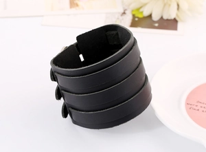 Macro view of black four-layer leather punk bracelet with three silver snap buttons