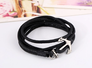 Detailed view of black wax rope braided bracelet with vintage silver anchor clasp