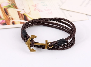 Close-up of multi-layer braided brown leather bracelet with vintage bronze anchor clasp