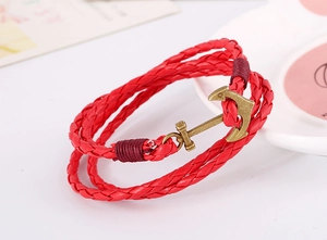 Detail of red multilayer woven leather bracelet featuring a bronze alloy anchor clasp