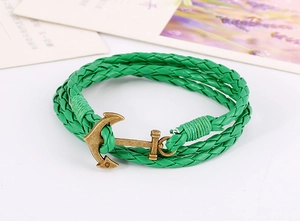 Macro shot of green braided leather bracelet with vintage bronze nautical anchor clasp