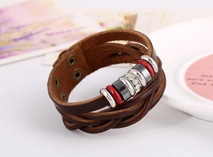 Detail of bohemian multilayer leather bracelet with metal rings, beads and rhinestone accents