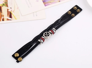 Detail of black multilayer braided leather bracelet with silver arrow charm and snap closure