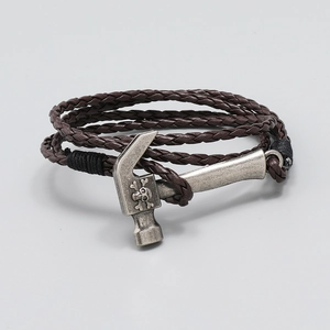 Detail of multi-layer braided leather bracelet featuring a silver skull hammer clasp
