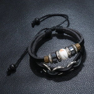 Multilayer leather bracelet with beads and vintage bronze rings on a dark leather base