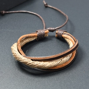 Detail of multi-layer braided vintage leather bracelet with adjustable hemp rope knot