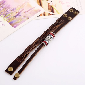 Fashionable braided brown leather bracelet with crystal accents and bronze metal studs