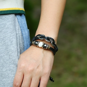 Macro detail of multi-layer leather bracelet with metal beads and white natural stone