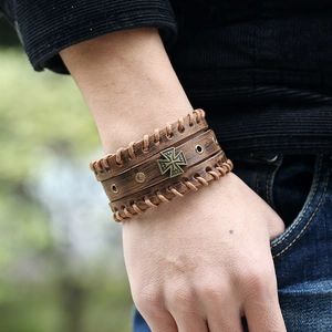 Vintage brown leather wristband with bronze cross accent and woven edges for men
