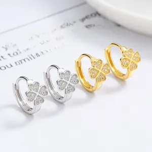 Close-up of 925 sterling silver clover earrings with paved crystals in gold and silver