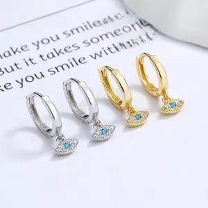 Close-up of silver and gold evil eye heart earrings with blue turquoise and cubic zirconia
