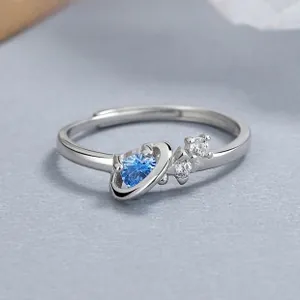 Detailed close-up of 925 sterling silver Saturn ring with blue heart-shaped zircon