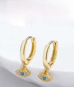 Macro view of 925 silver evil eye earrings with gold plating and blue cubic zirconia