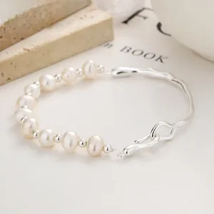 Detail of 925 sterling silver curved tube bracelet with natural 8-9mm pearls and S-hook