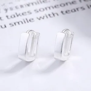 Close-up of minimalist S925 sterling silver rectangular hoop earrings with a polished finish