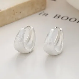 Macro view of 925 sterling silver square hoop earrings with a sleek brushed matte finish