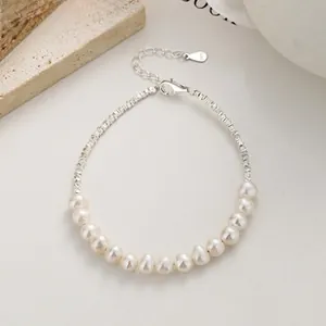 Detailed close-up of 925 sterling silver chain with pearls and lobster clasp closure