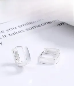 Close-up of S925 sterling silver square hoop earrings with a matte brushed finish texture