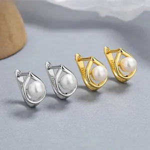 Detail of silver and gold S925 sterling silver hoop earrings with round pearls