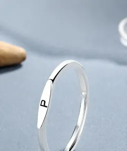 Macro detail of S925 sterling silver ring featuring a black engraved letter P on a flat disc