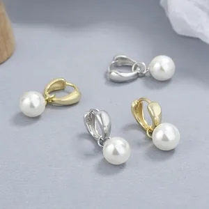 Macro shot of S925 sterling silver hallmarked earrings with lustrous round pearls