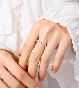 Macro detail of minimalist 925 sterling silver ring with engraved B letter on finger