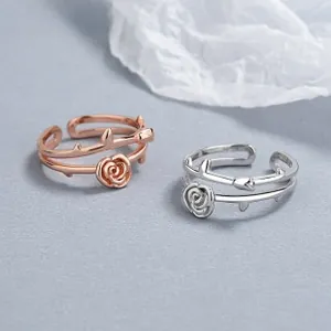 Detailed close-up of 925 silver open rose rings with thorn texture and rose gold finish