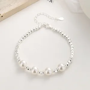 Detail of silver beaded bracelet with four lustrous pearls and adjustable lobster clasp