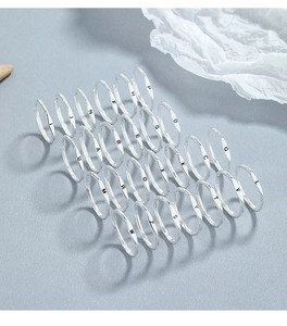 Full collection of 925 sterling silver minimalist A-Z initial rings on light grey surface