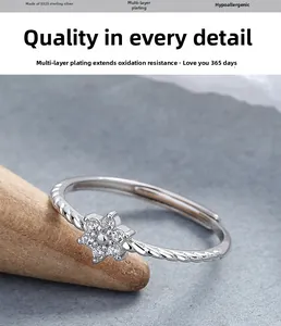 Macro detail of S925 sterling silver flower ring with zircon on a wooden display