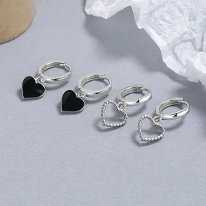 Detail of 925 sterling silver heart hoop earrings with black enamel and beaded charms