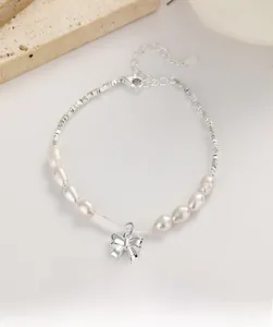 Macro detail of S925 silver bow bracelet with lustrous pearls and irregular silver beads