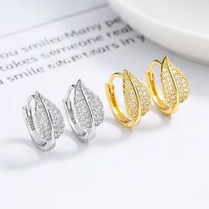 Detailed macro view of S925 sterling silver and gold leaf hoop earrings with zircon