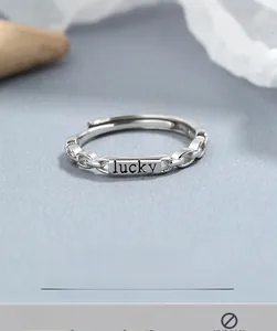 Macro shot of S925 sterling silver lucky chain ring with square engraved plate
