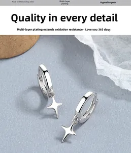 Detailed close-up of S925 sterling silver hoop earrings with four-pointed star charms
