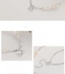 Macro detail of 925 sterling silver chain with irregular pearls and a bow pendant