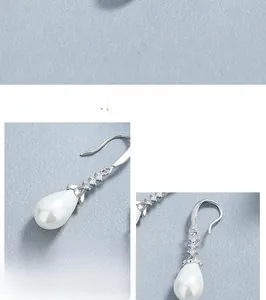 Detailed view of 925 sterling silver pearl drop earrings with sparkling crystals
