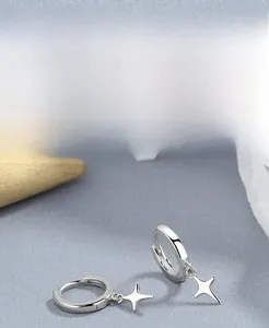 Detailed close-up of S925 sterling silver hoop earrings with four-pointed star charms