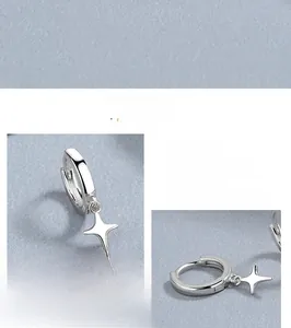 Detailed close-up of 925 sterling silver hoop earrings with minimalist star pendants