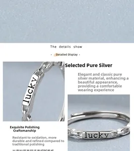 Macro detail of silver chain ring featuring Lucky engraving and polished mirror finish