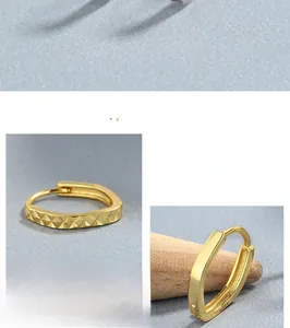 Macro detail showing the S925 hallmark and textured geometric surface of gold silver earrings