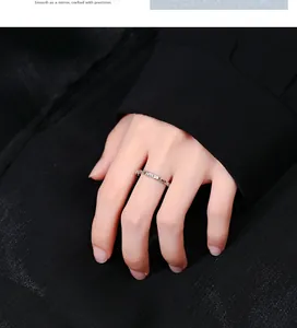 Macro detail of 925 sterling silver chain ring with Lucky engraving on black fabric