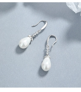 Detail view of 925 silver hook earrings with white teardrop pearls and cubic zirconia