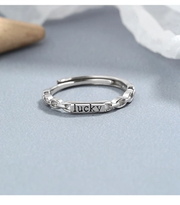 Detail of S925 sterling silver chain ring featuring an engraved lucky tag and open band