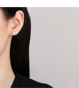 Detailed view of elegant white pearl stud earring with V-shaped silver diamond setting