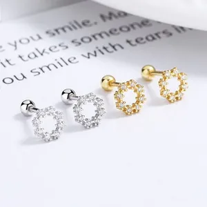Detail of 925 sterling silver hollow flower stud earrings with sparkling cubic zirconia