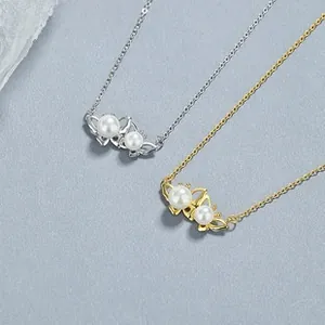 Vue détaillée de colliers papillon en argent 925 avec perles blanches en doré et argenté