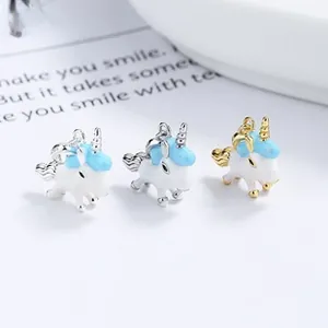 Detailed view of three enamel unicorn pendants in silver and gold plating for jewelry making