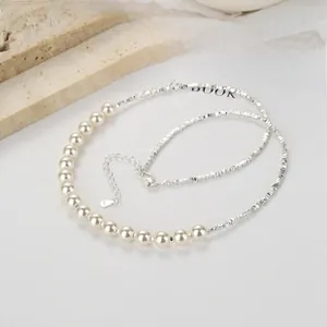 Detailed view of 925 silver irregular chain and pearl necklace with lobster clasp