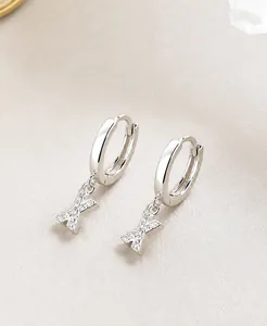 Detailed view of S925 sterling silver hoop earrings with zircon pavé letter X pendant